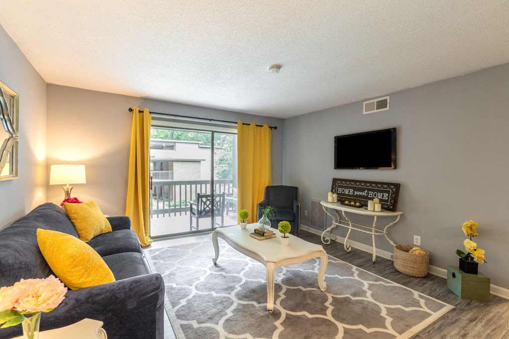 a living room with a couch and a table and a tv