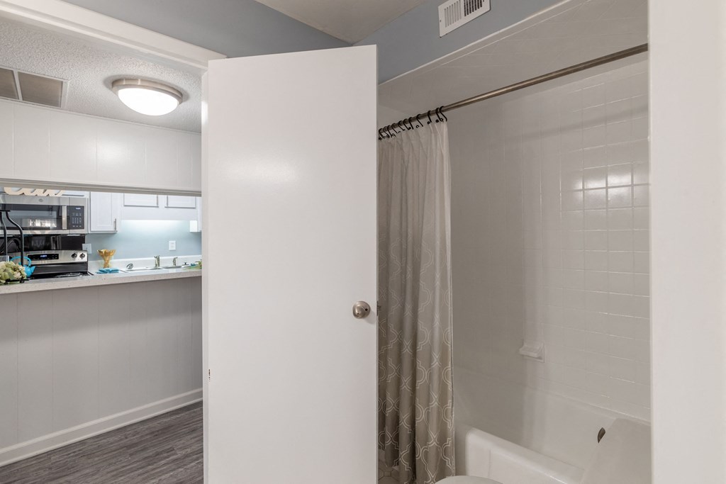 a bathroom with a shower and a sink and a toilet