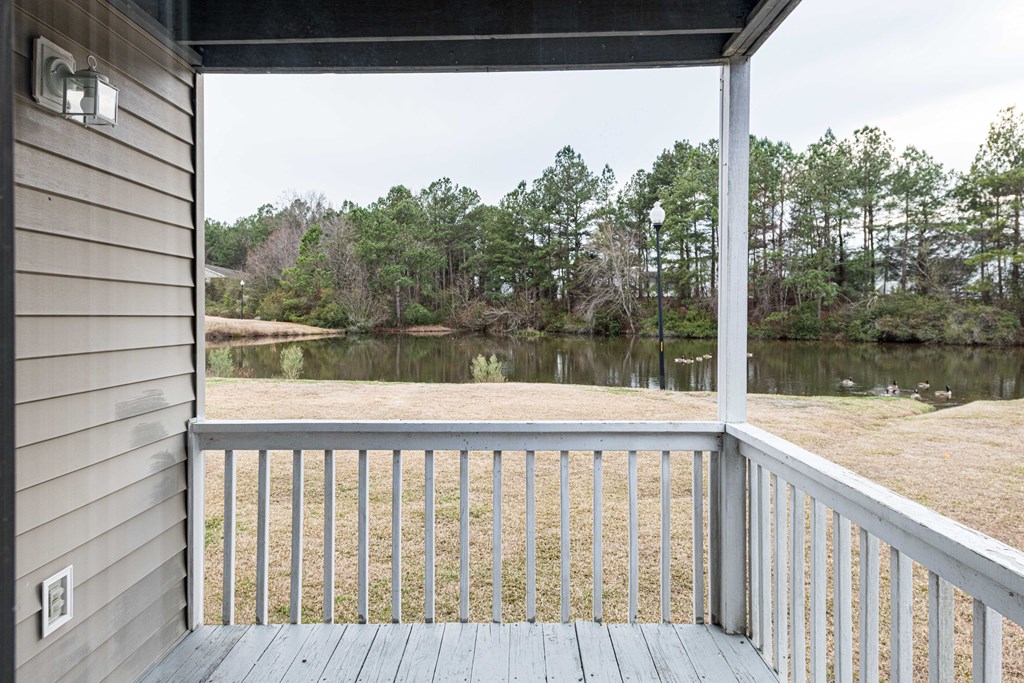 the view of the lake from the porch of a house