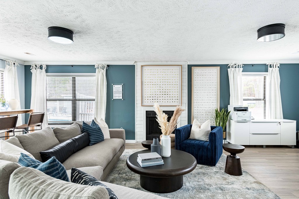 a living room with blue walls and a couch and a table