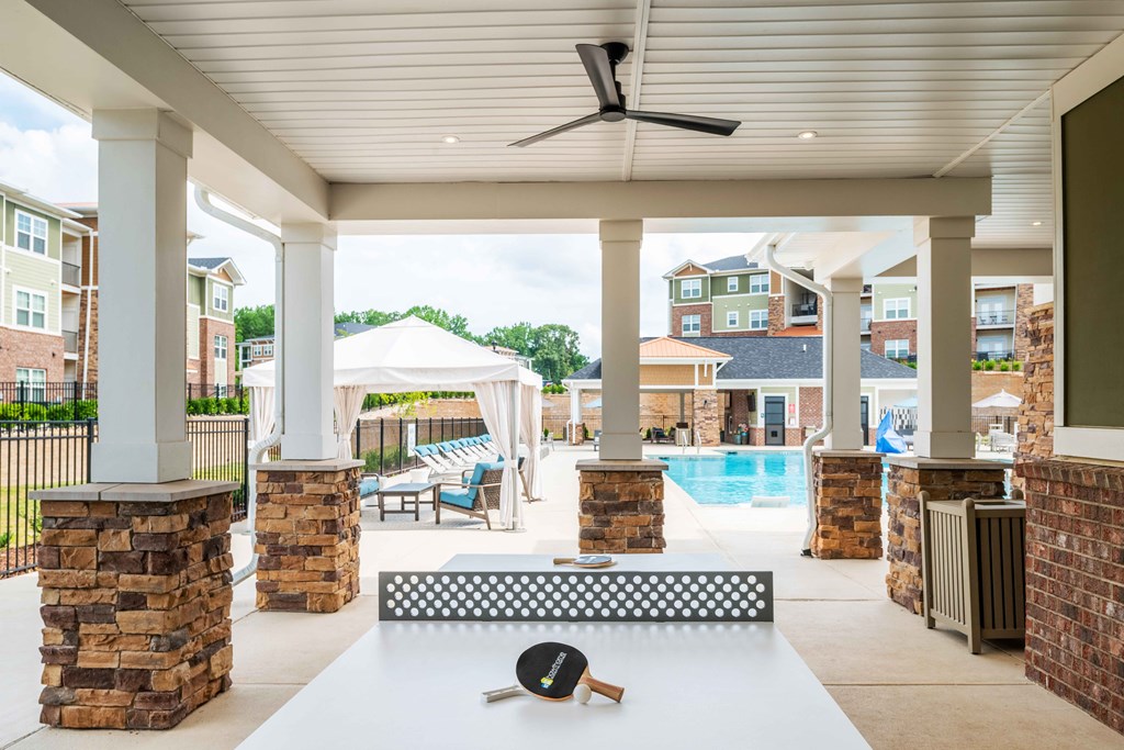 the preserve at ballantyne commons pool area with a white table and a pool