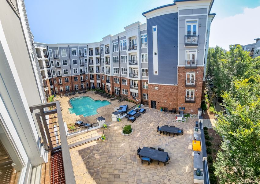 an aerial view of a large courtyard with a pool and patio furniture - Photo Gallery