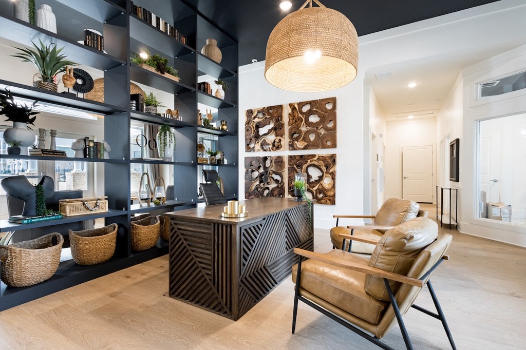 a home office with a black and white chevron desk and leather chair