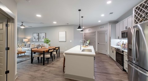 A modern kitchen with a dining table and chairs.
