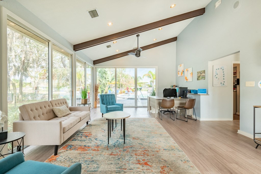 a living room with a couch chairs and a coffee table in front of a sliding glass door