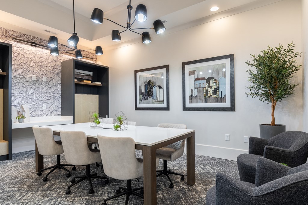 a conference room with a table and chairs and a plant