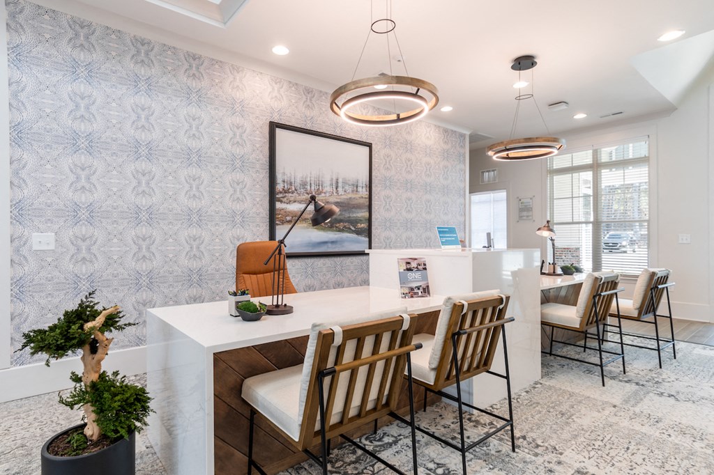 a kitchen with a long counter and chairs and a dining room with chairs and tables