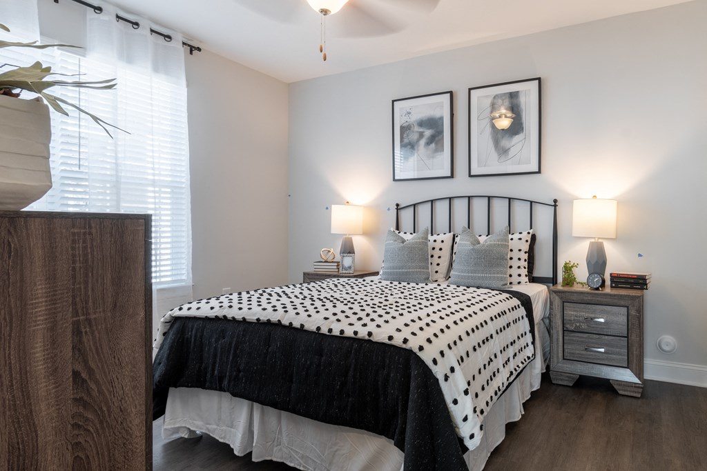 a bedroom with a bed and a dresser and a window