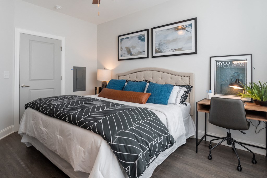 a bedroom with a bed and a desk with a chair