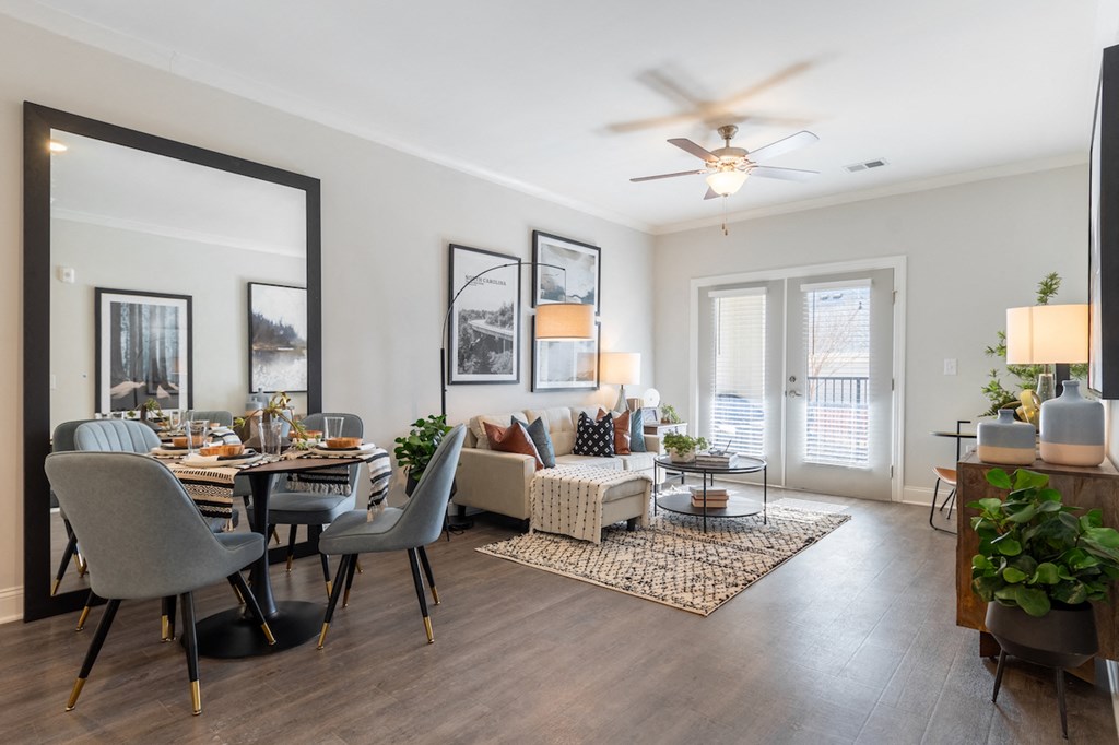 a living room and dining room with a ceiling fan