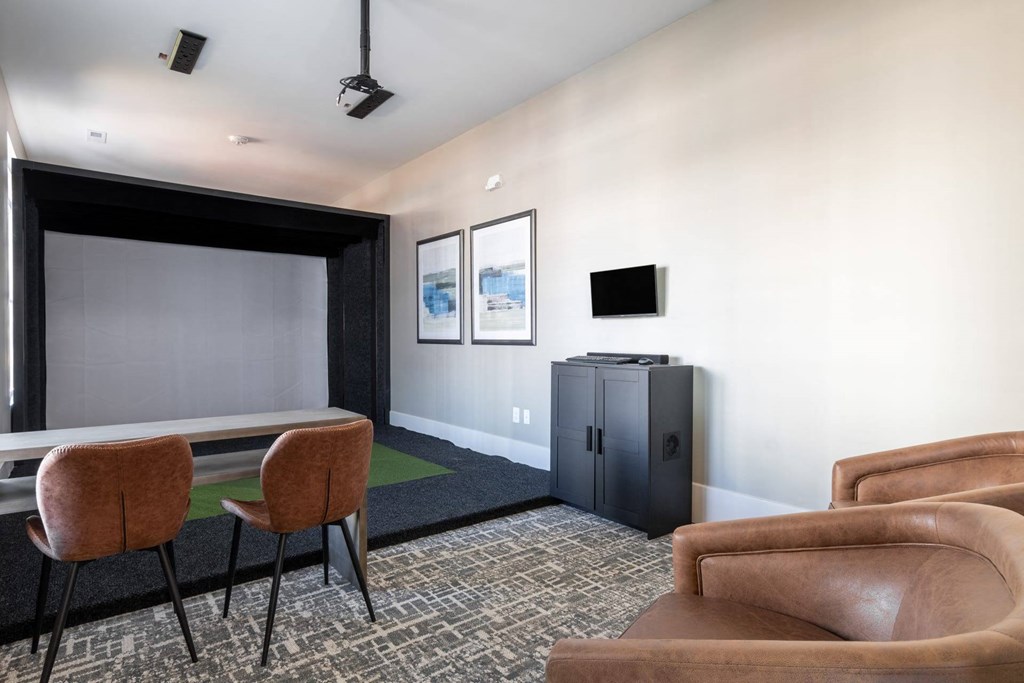 a conference room with a table and chairs and a television