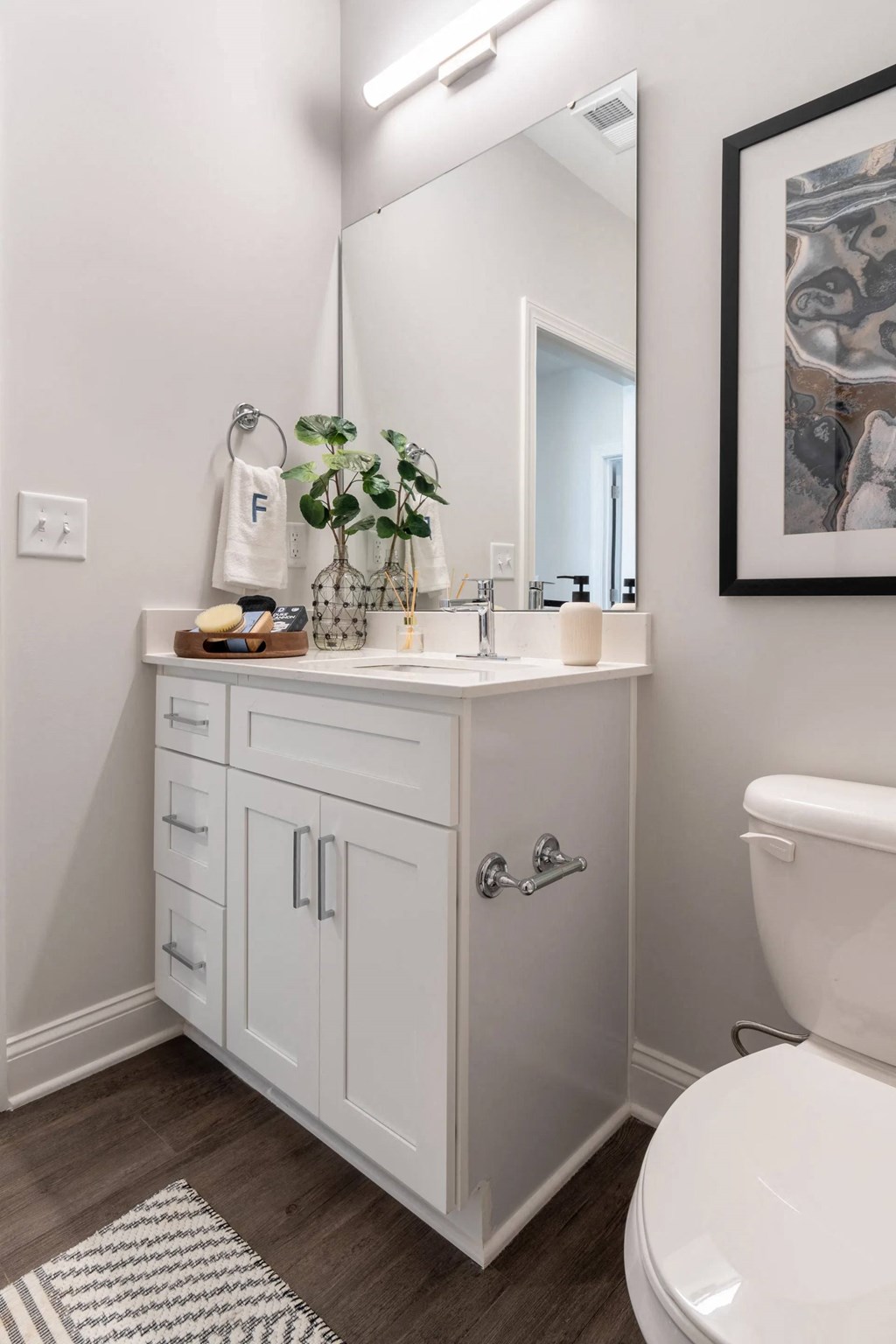 a white bathroom with a toilet and a sink