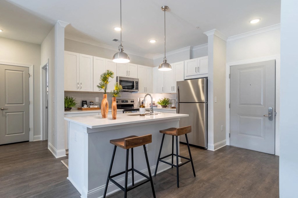 a kitchen with a large island and two bar stools