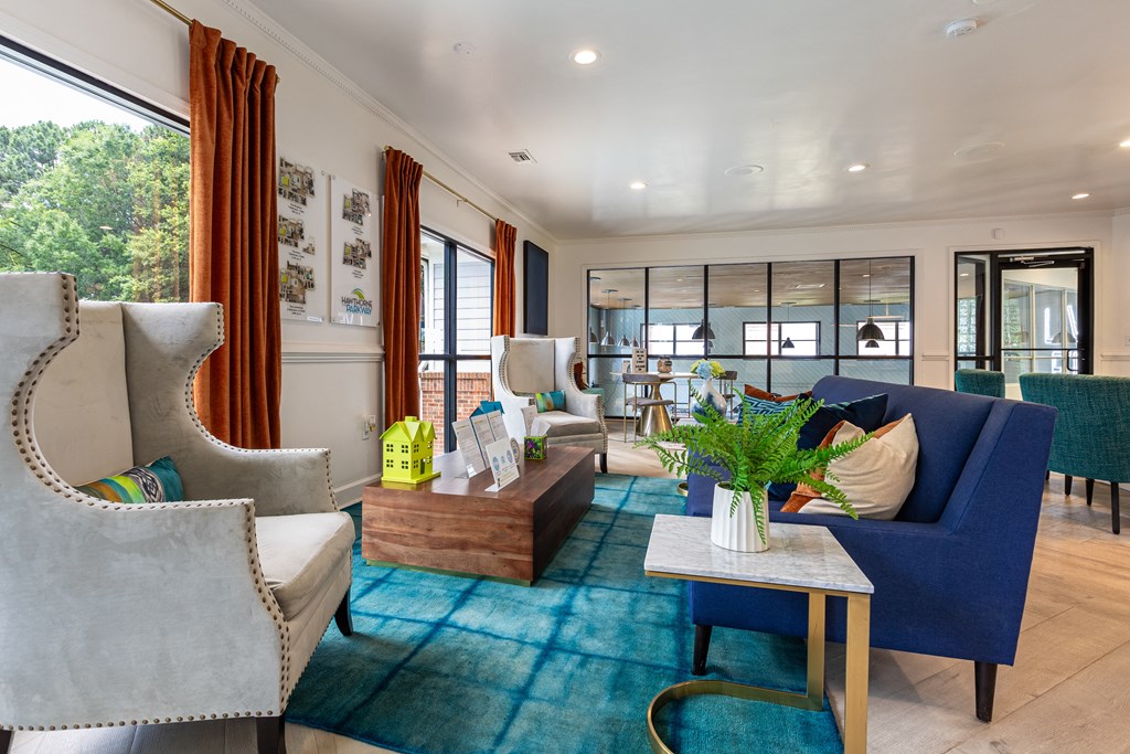 a living room with blue furniture and a blue rug