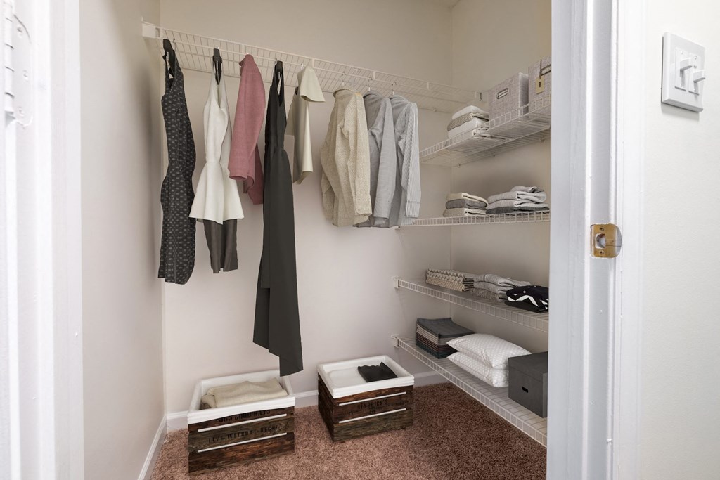 a small walk in closet with shelves and baskets