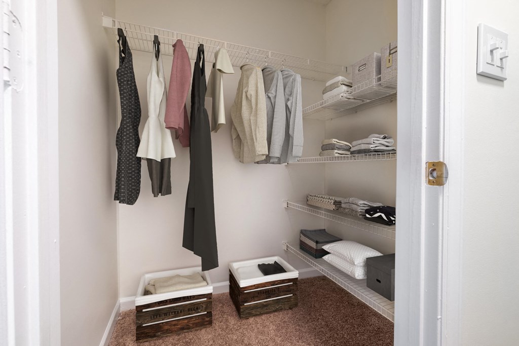 a small walk in closet with shelves and baskets