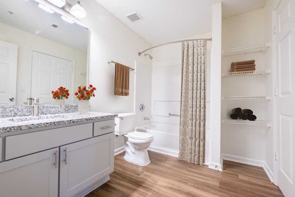 a bathroom with a toilet and a shower with a curtain