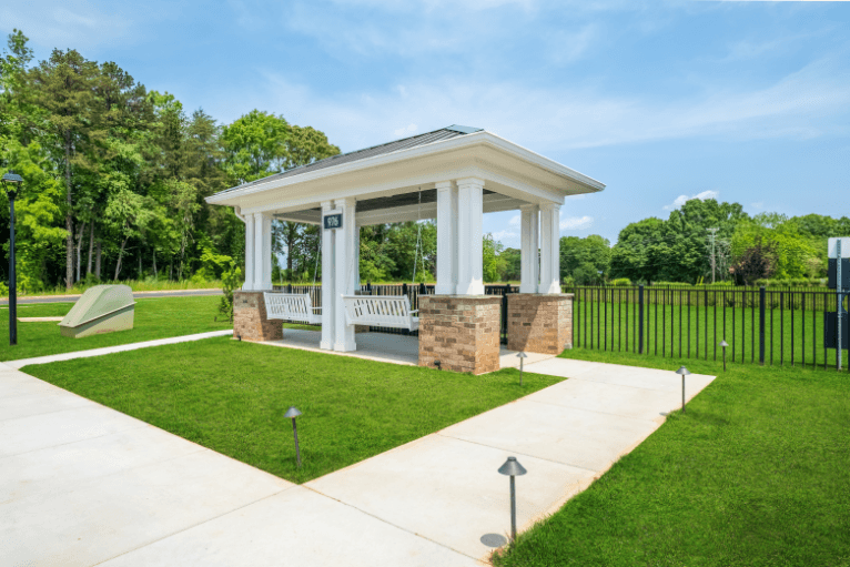 a gazebo with a bench and a pavilion in a park