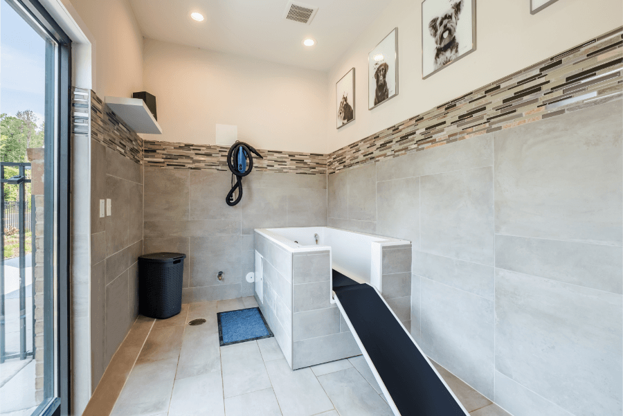 a bathroom with a tub and a shower and a sliding glass door