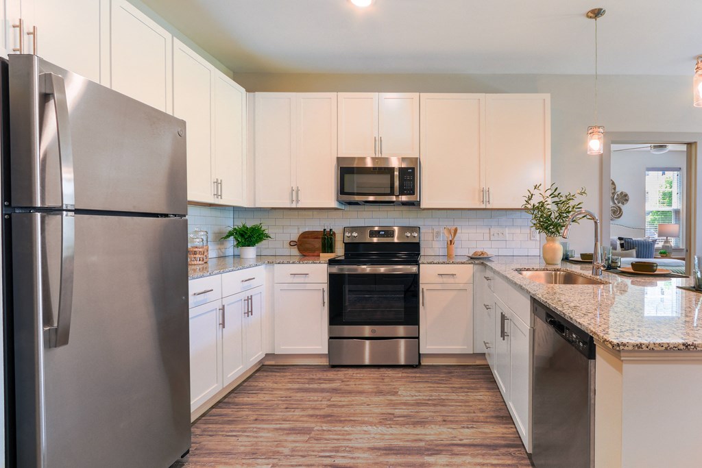 a kitchen with stainless steel appliances and white cabinets
