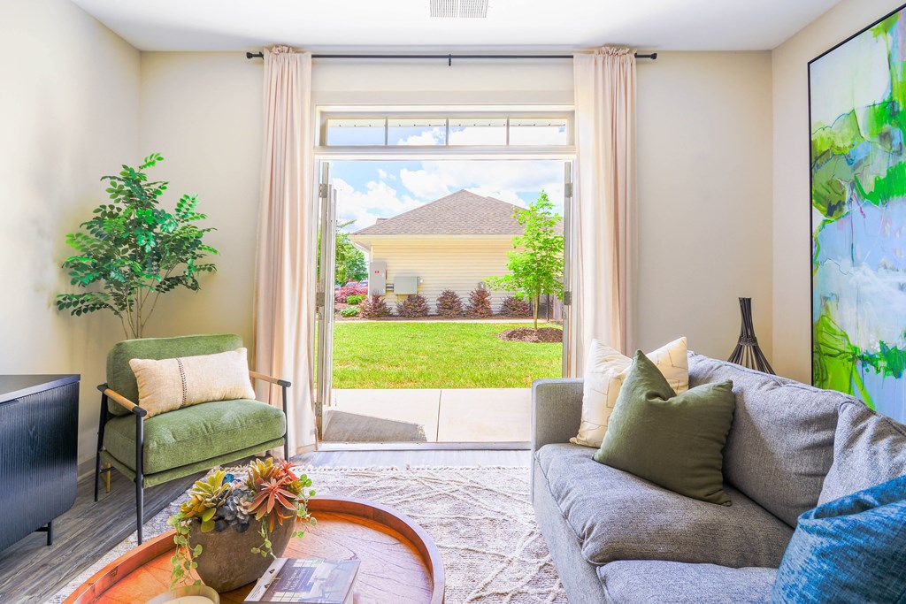 a living room with a view of a house through a window