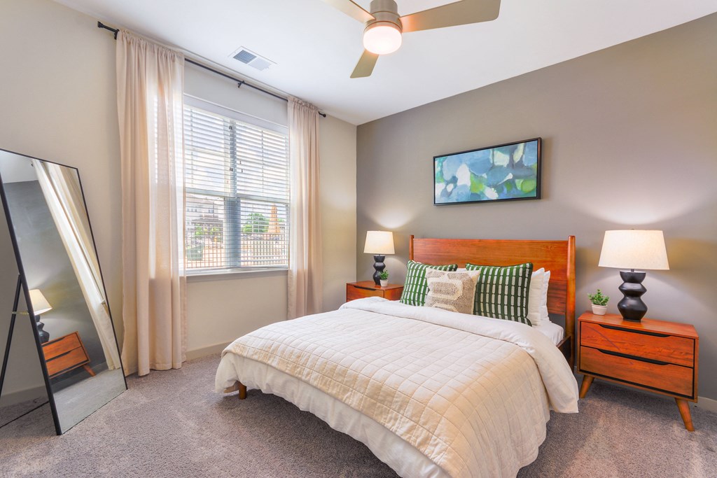 a bedroom with a bed and a large window