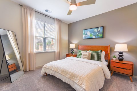 a bedroom with a bed and a large window