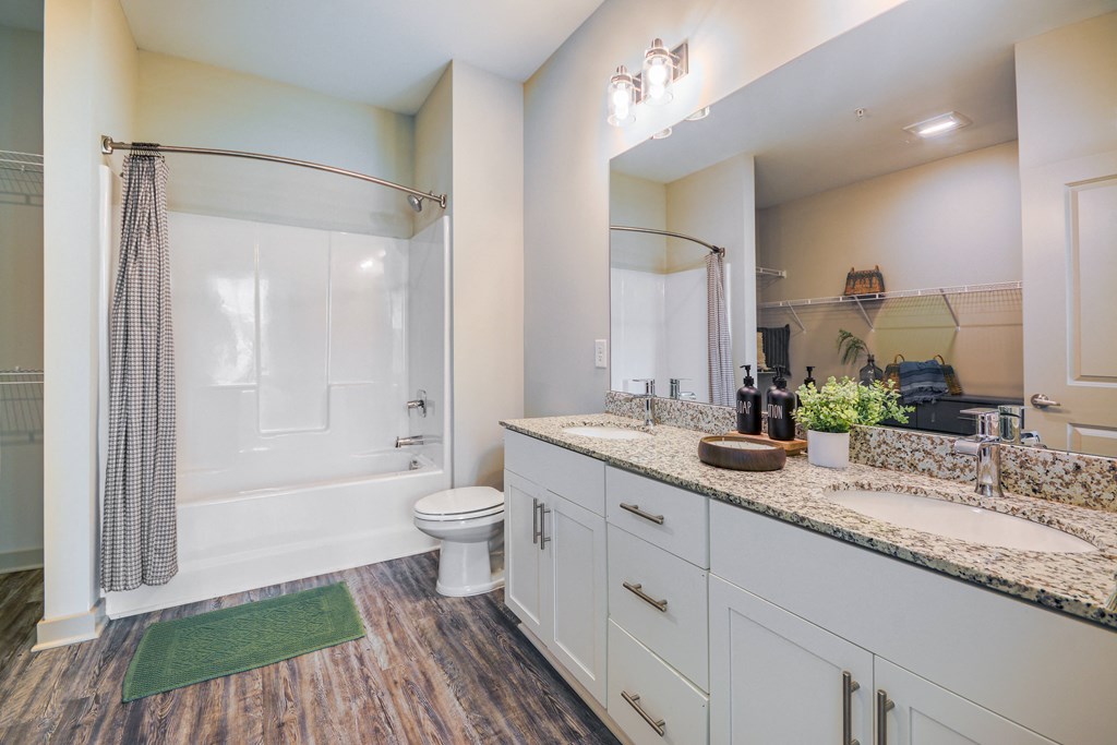 a bathroom with a shower and a sink and a toilet