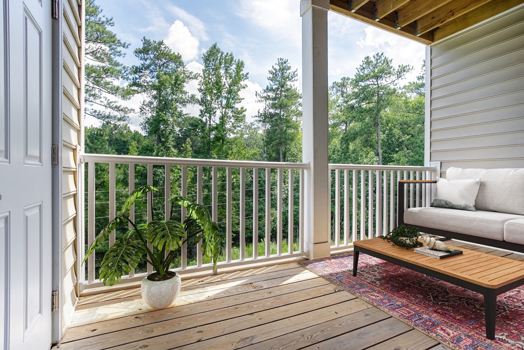 a porch with a plant and a couch on it