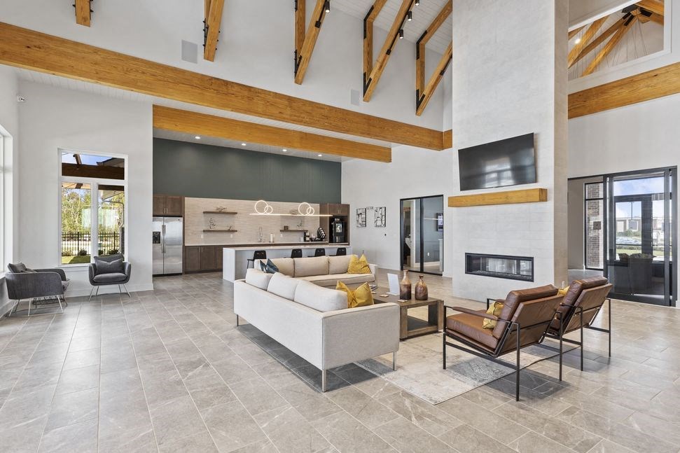 a large living room with a white couch and a fireplace