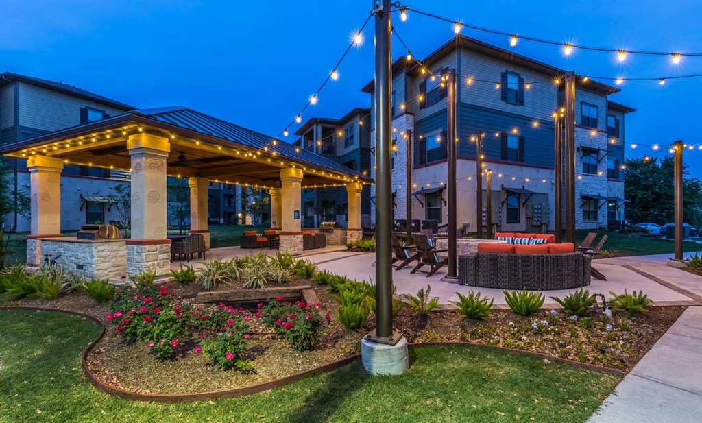 a patio with a fire pit at night
