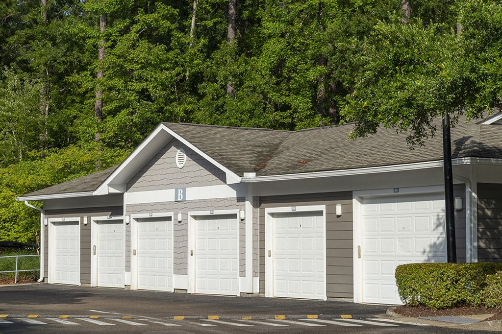 a row of garages with white garage doors