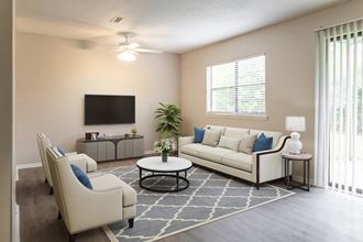 an open living room with couches and chairs and a tv