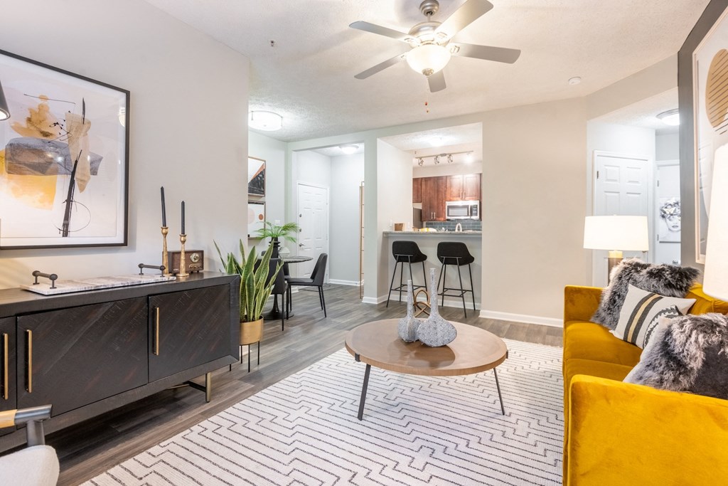 an open living room and kitchen with a ceiling fan
