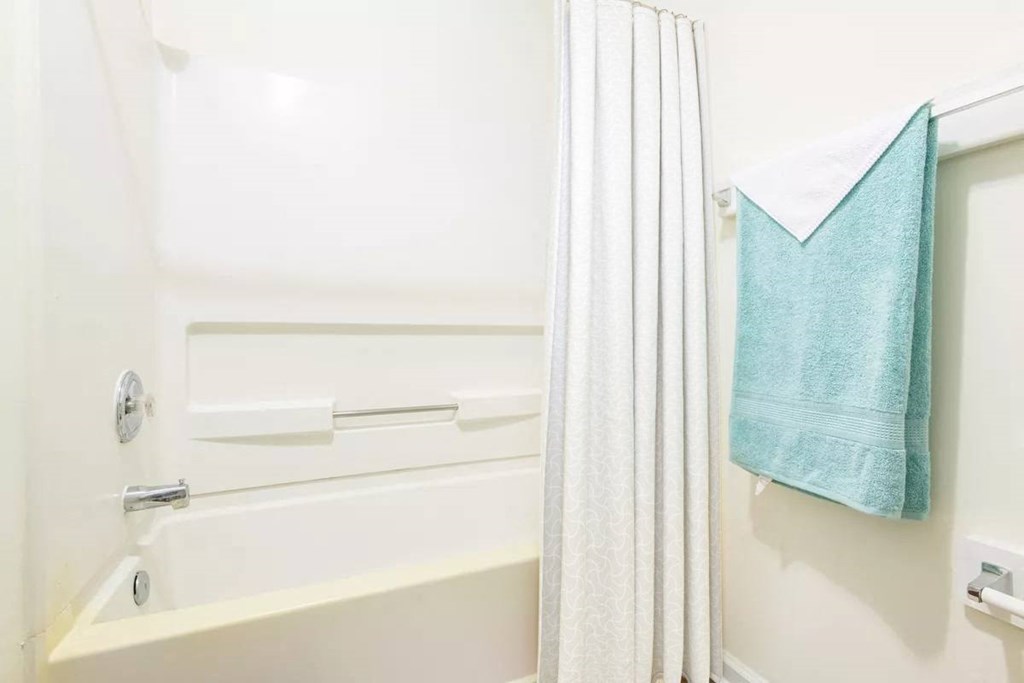 a bathroom with a shower curtain and a bath tub