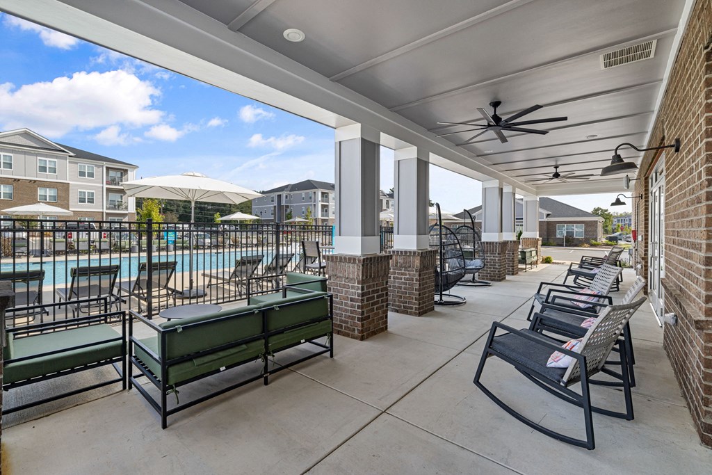 the pool area at the preserve at polo terrace with lounge chairs and tables
