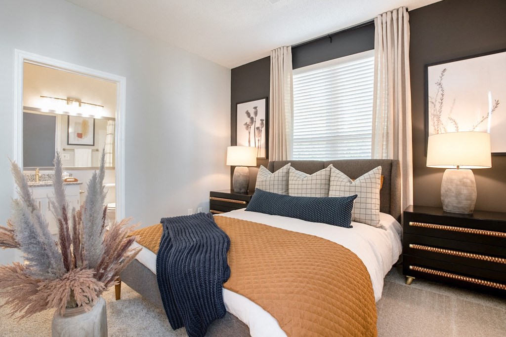 a bedroom with a large bed and a window