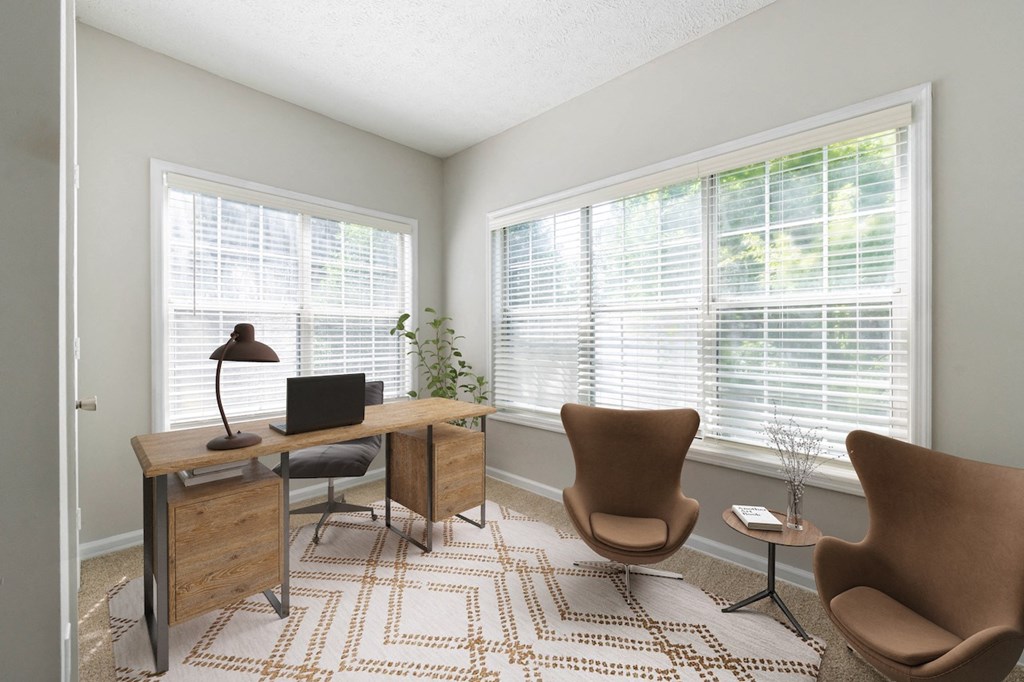 a home office with two chairs and a desk with a computer on it