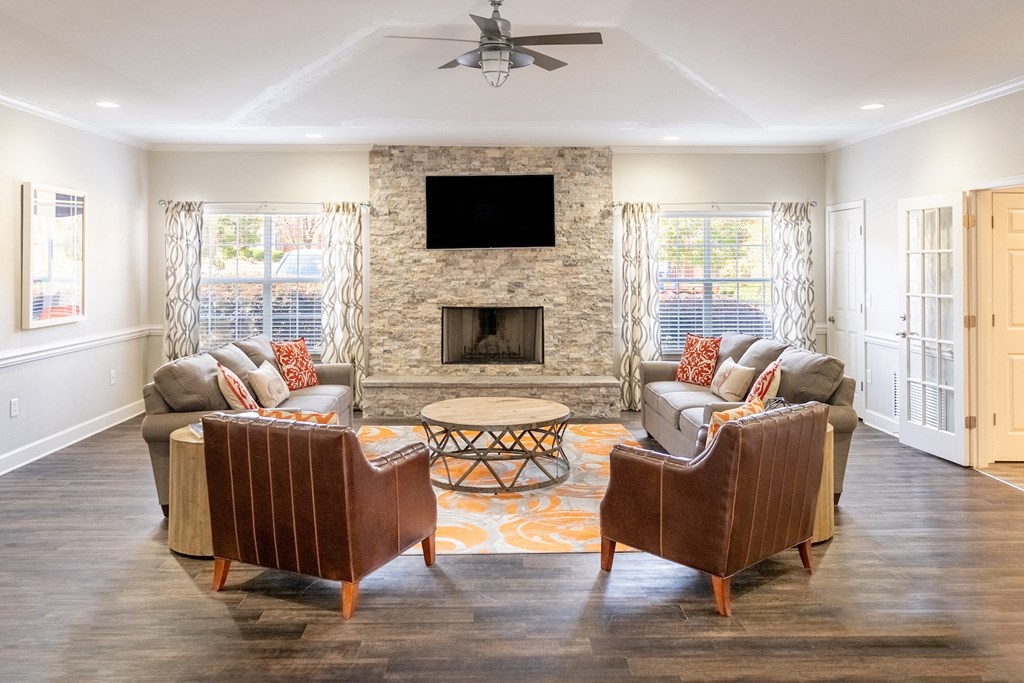 a living room with couches and chairs and a fireplace