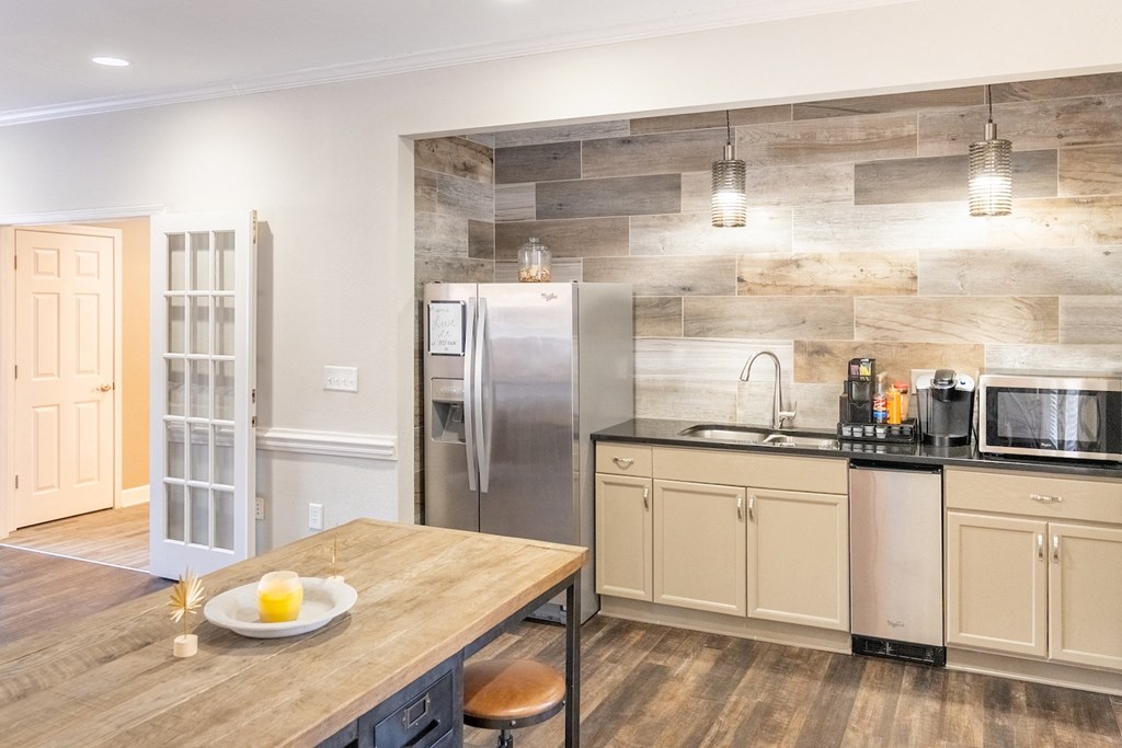 a kitchen with stainless steel appliances and a wooden table