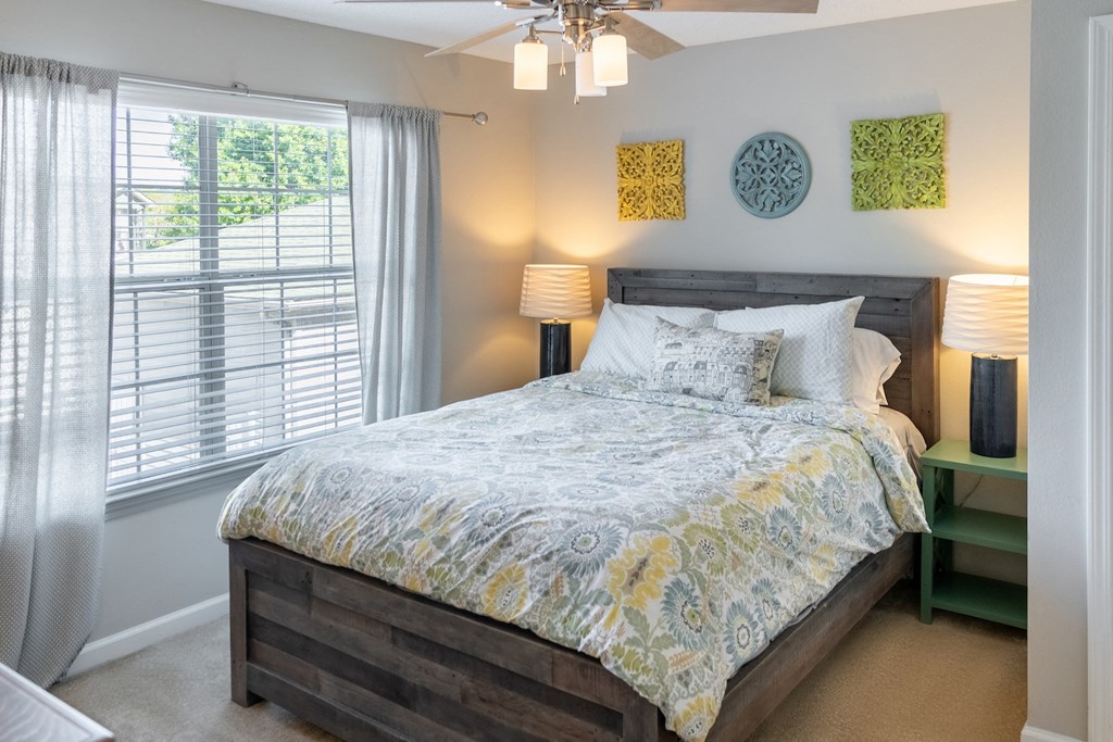 a bedroom with a bed and a ceiling fan