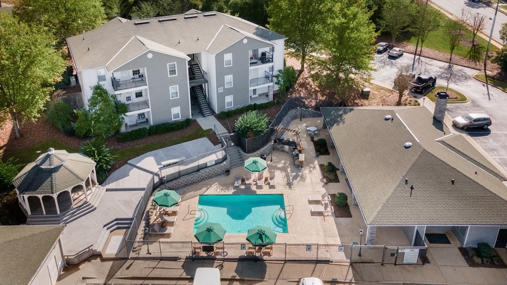 an aerial view of an apartment complex with a swimming pool