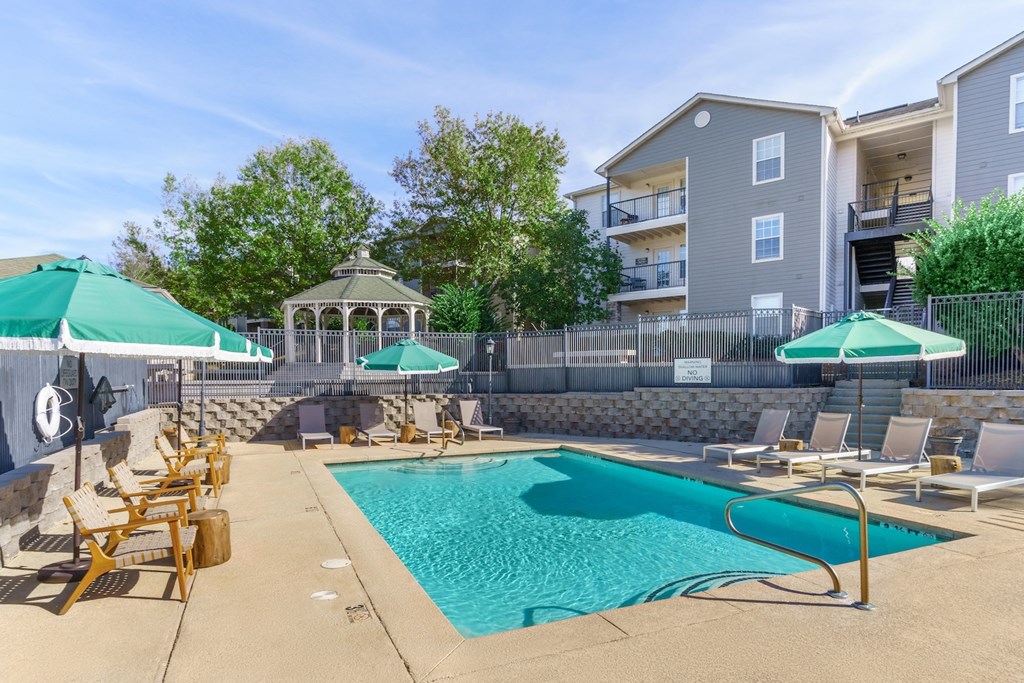 our apartments have a swimming pool with chairs and umbrellas