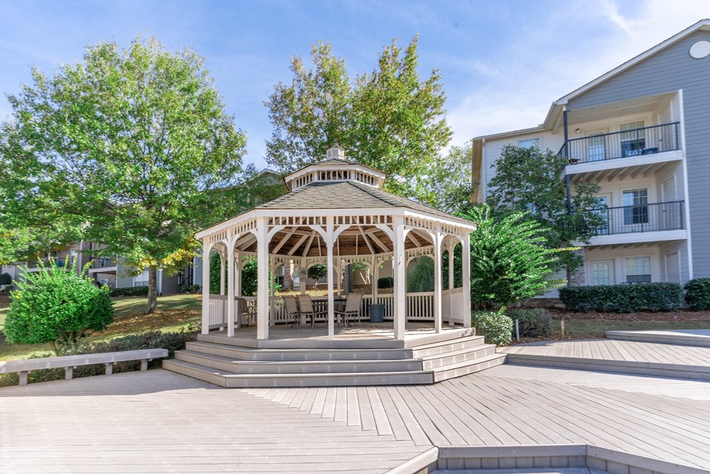 a gazebo with a table and chairs in the middle of a building