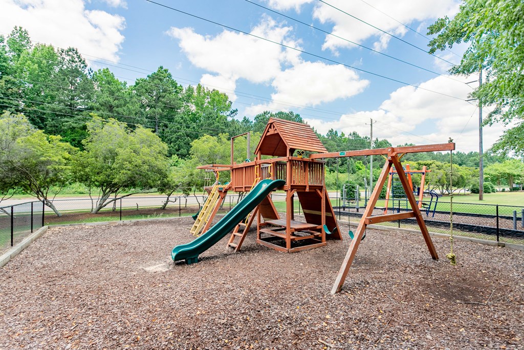 a playground with a swing set and a slide