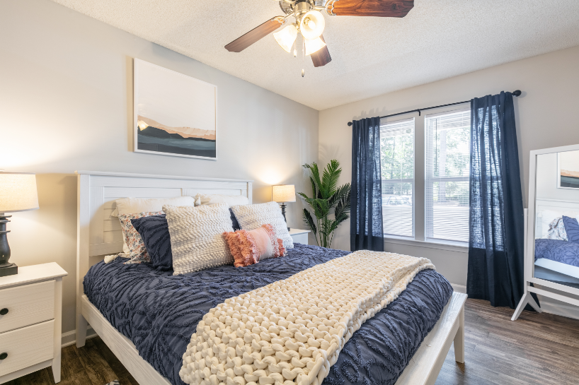 a bedroom with a bed and a ceiling fan
