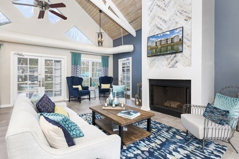 a living room with blue and white furniture and a fireplace