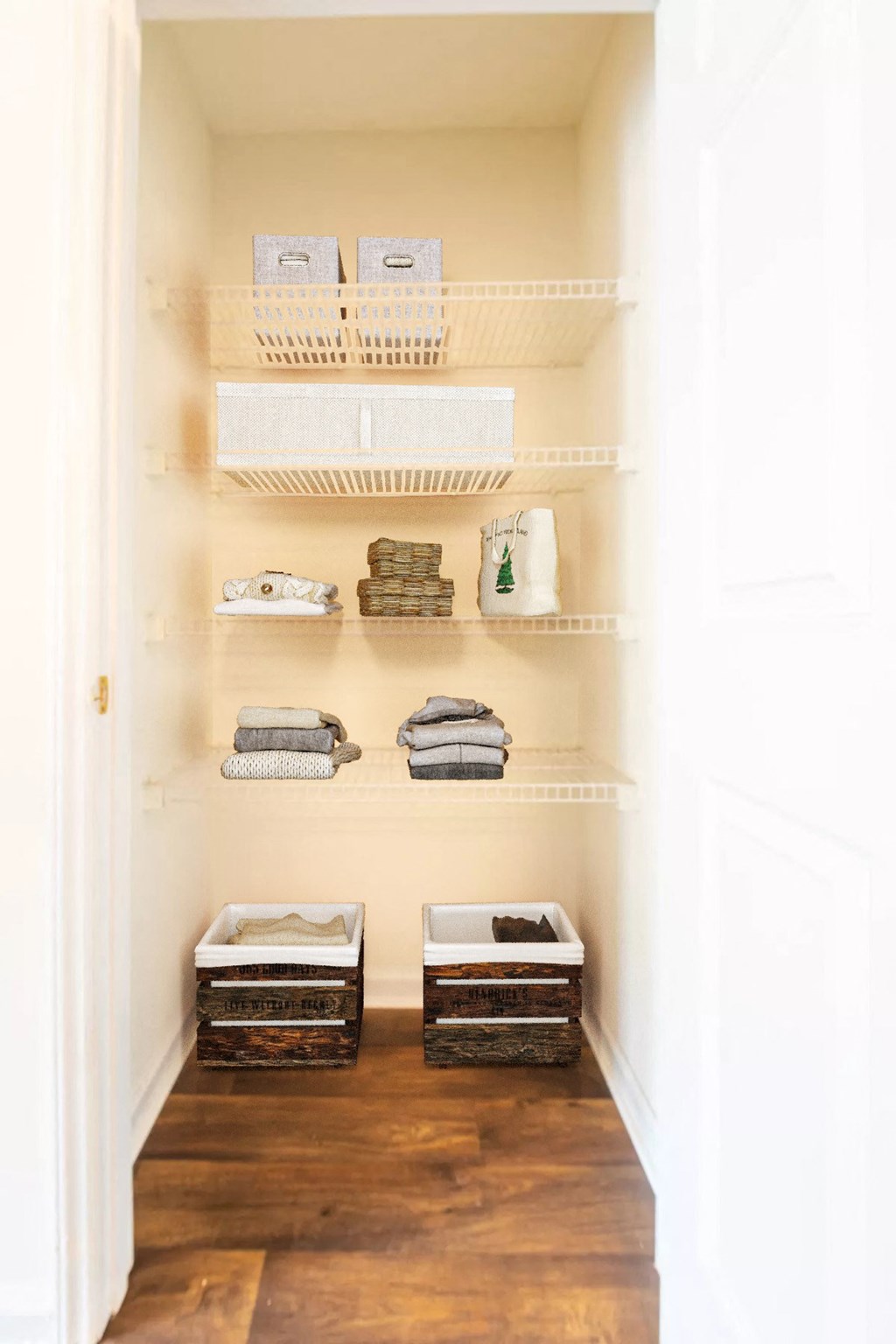 a small closet with shelves and baskets on it