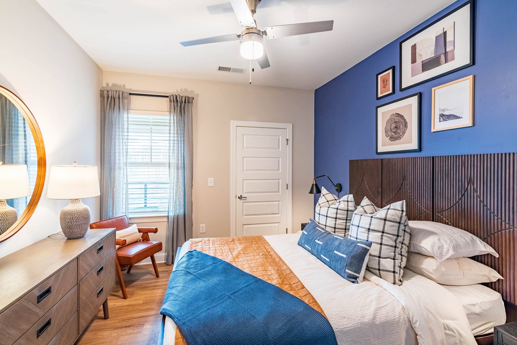 a bedroom with a bed and a ceiling fan