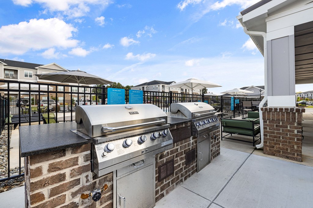 the preserve at ballantyne commons commons outdoor kitchen with two grills and chairs
